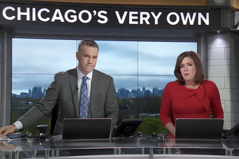 2 WGN news anchors behind desk on set