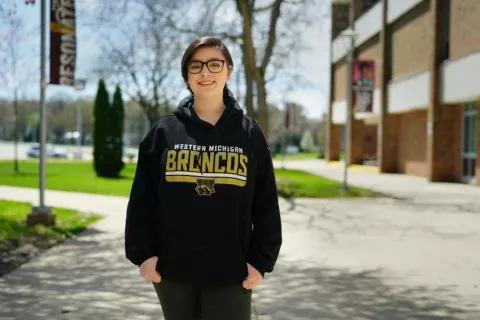 young woman wearing a black hoodie outside smiling: https://wmich.edu/firstyearfaces/liberty-kostrzewa