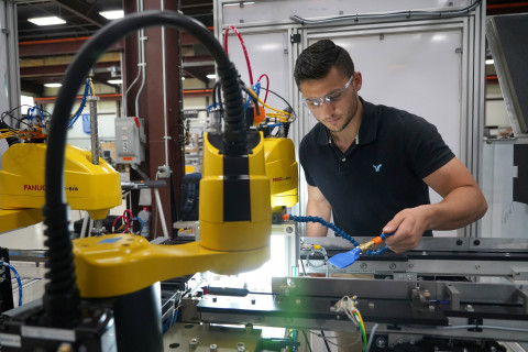 A student working on a piece of machinery.