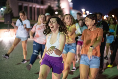 Students walking at night on campus.