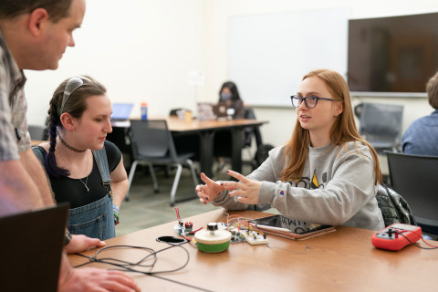 Students discussing circuits with instructors