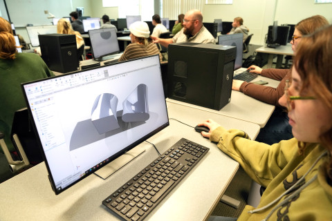 Student working at computer with CAD
