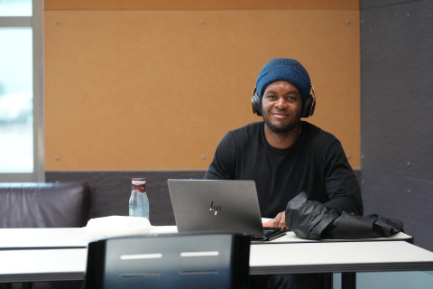 Student in background with laptop