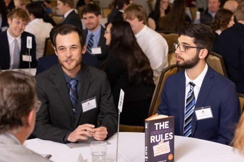 Paper engineering students talking to industry professionals at their fall meeting mentoring tables. 