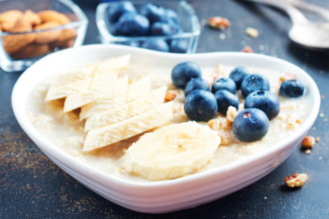 Bananas, blueberries and oatmeal in a heart shaped bowl