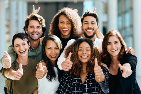 Diverse group of people with their thumbs up smile and being positive