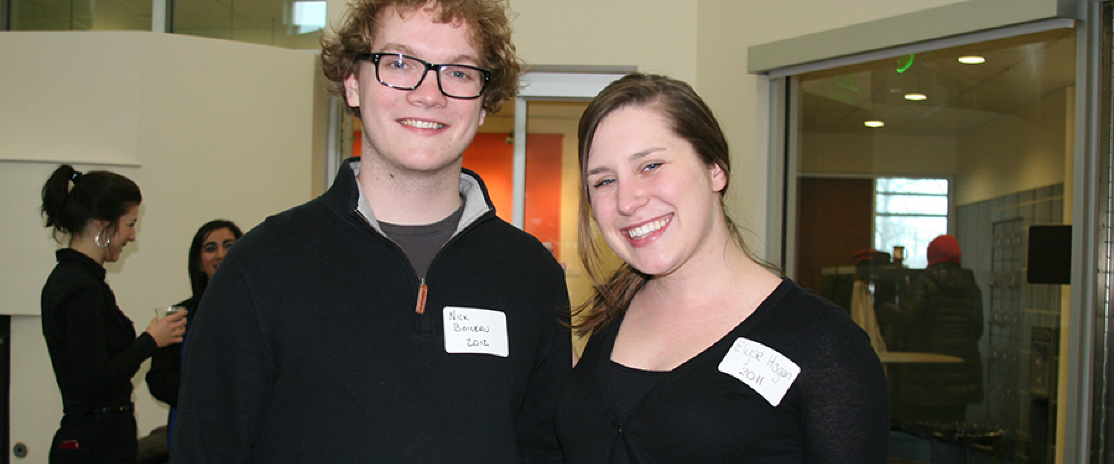 One male and one female Medallion alum attending a reunion in the honors college lounge.