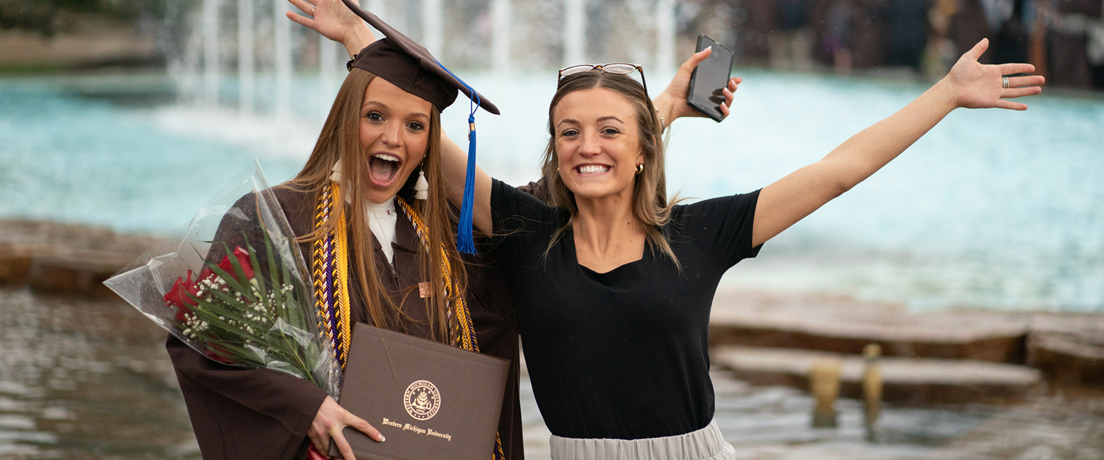 Honors college grads in front of Miller Fountain.