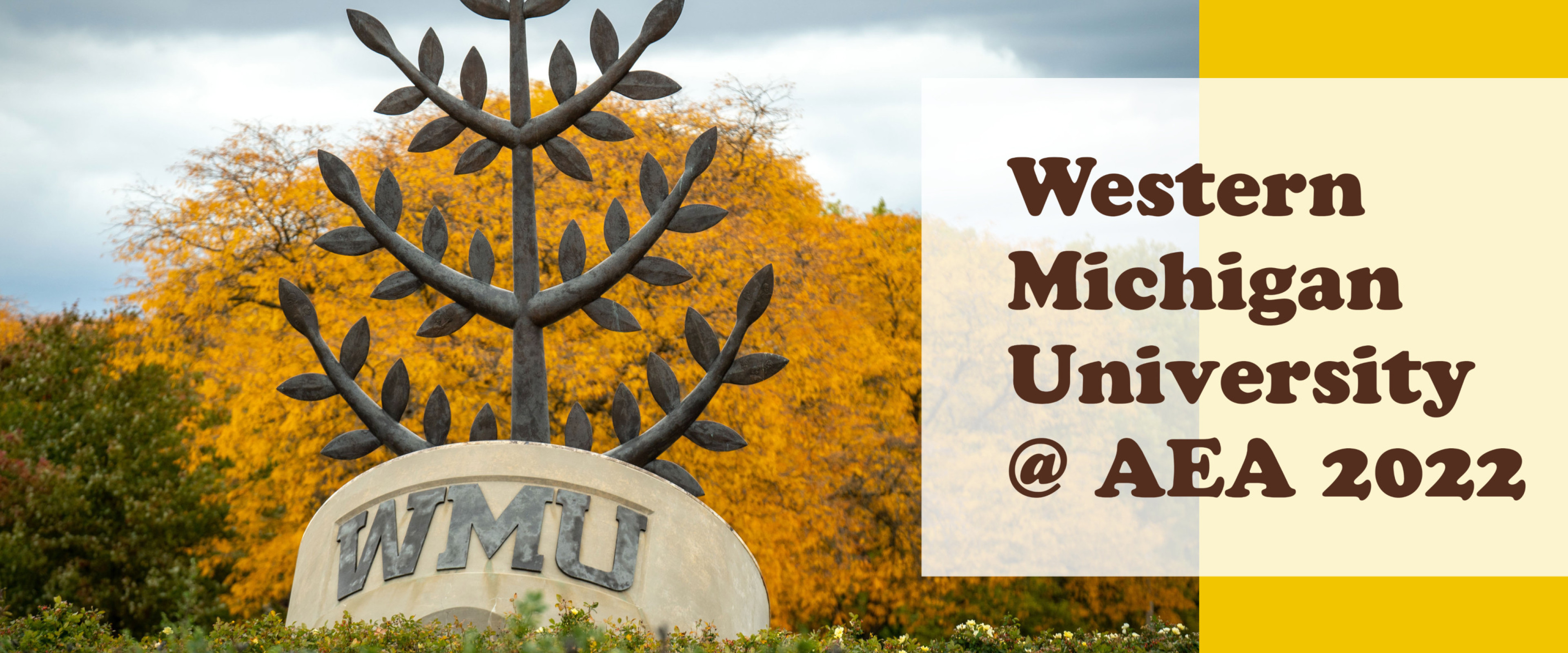 WMU seal sculpture in front of fall foilage