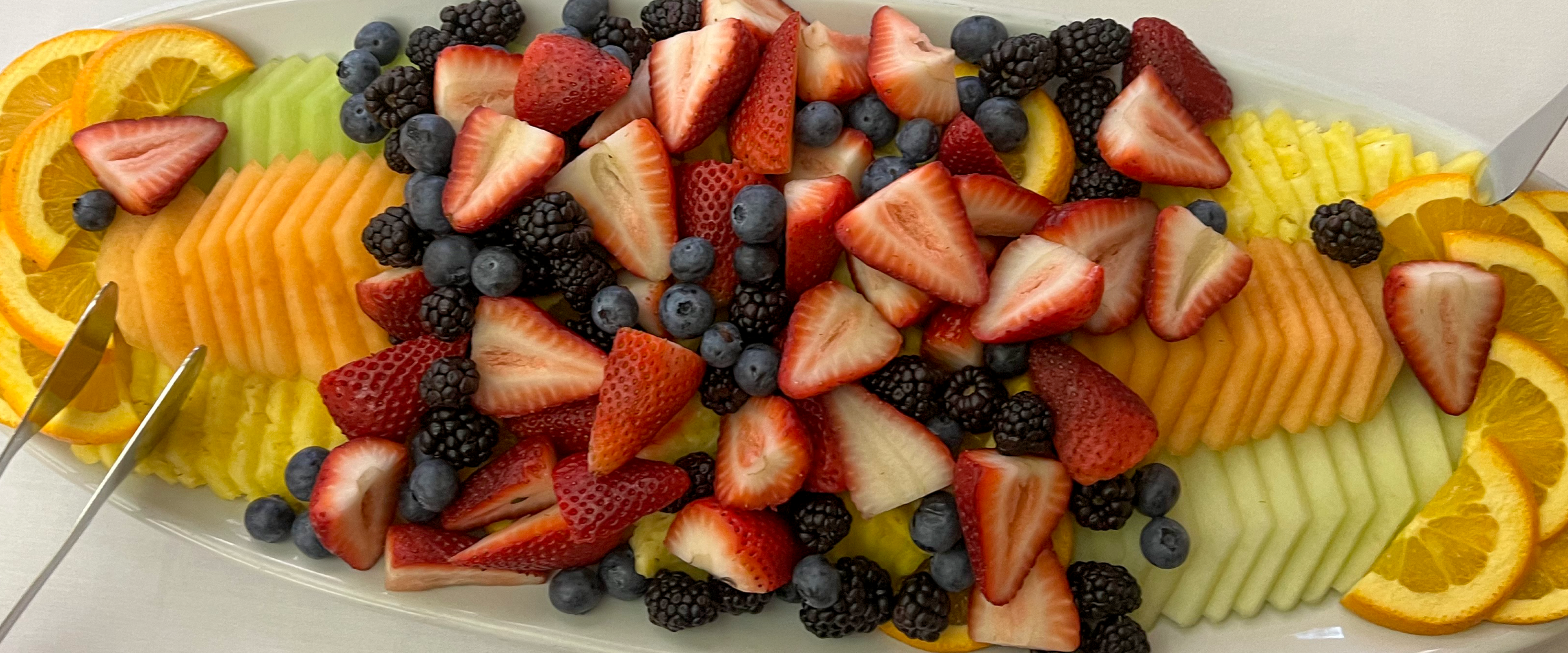 Platter of fruit; strawberries, blueberries, melons, pineapple and oranges