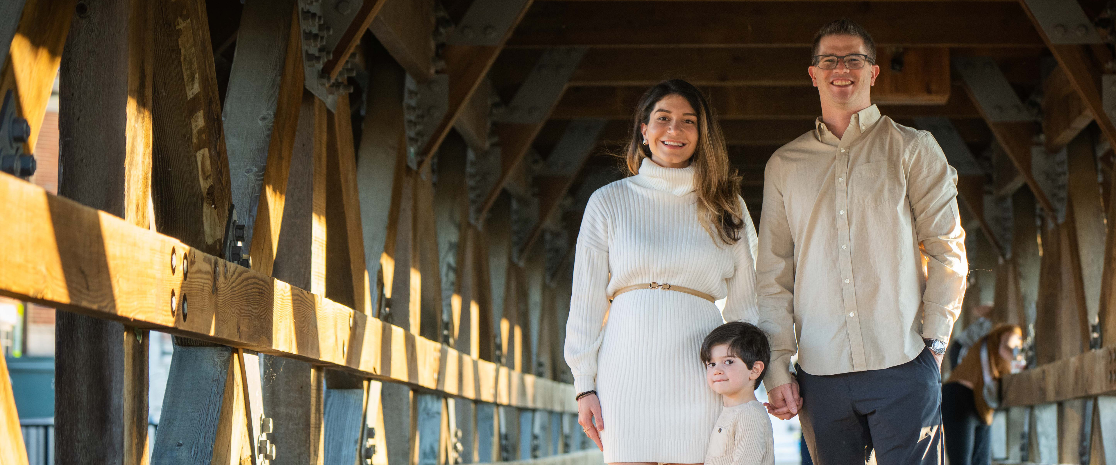 A family portrait of the Elshafeis under a bridge.