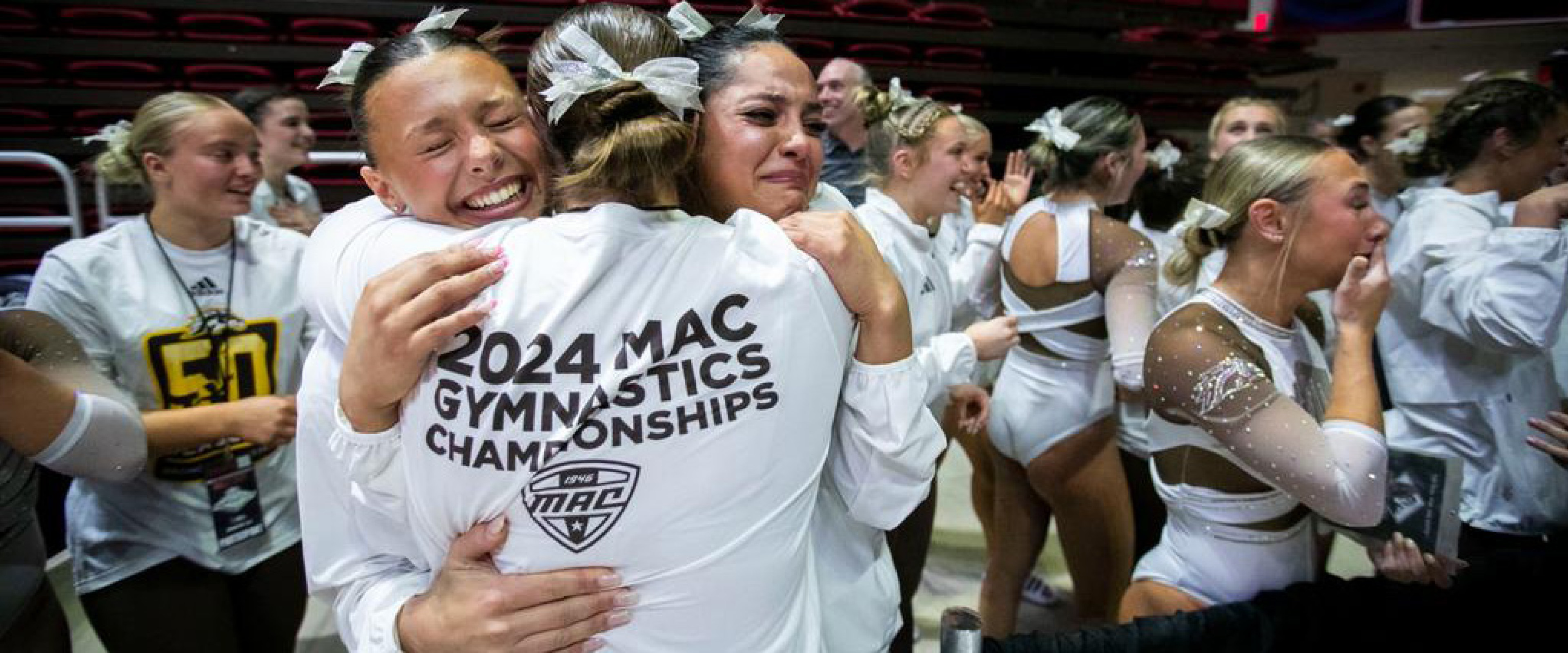 WMU gymnasts hug each other in celebration.