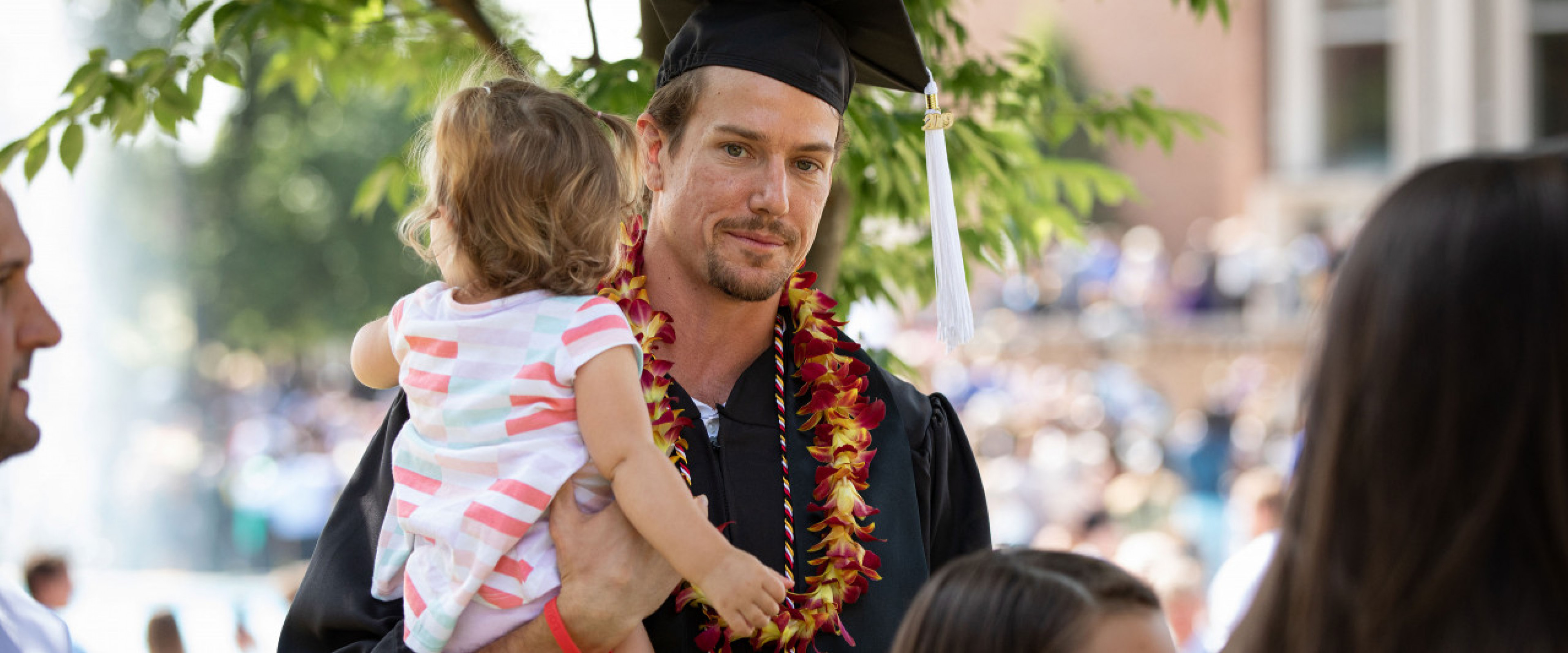 Page banner: WMU graduate smiling with baby