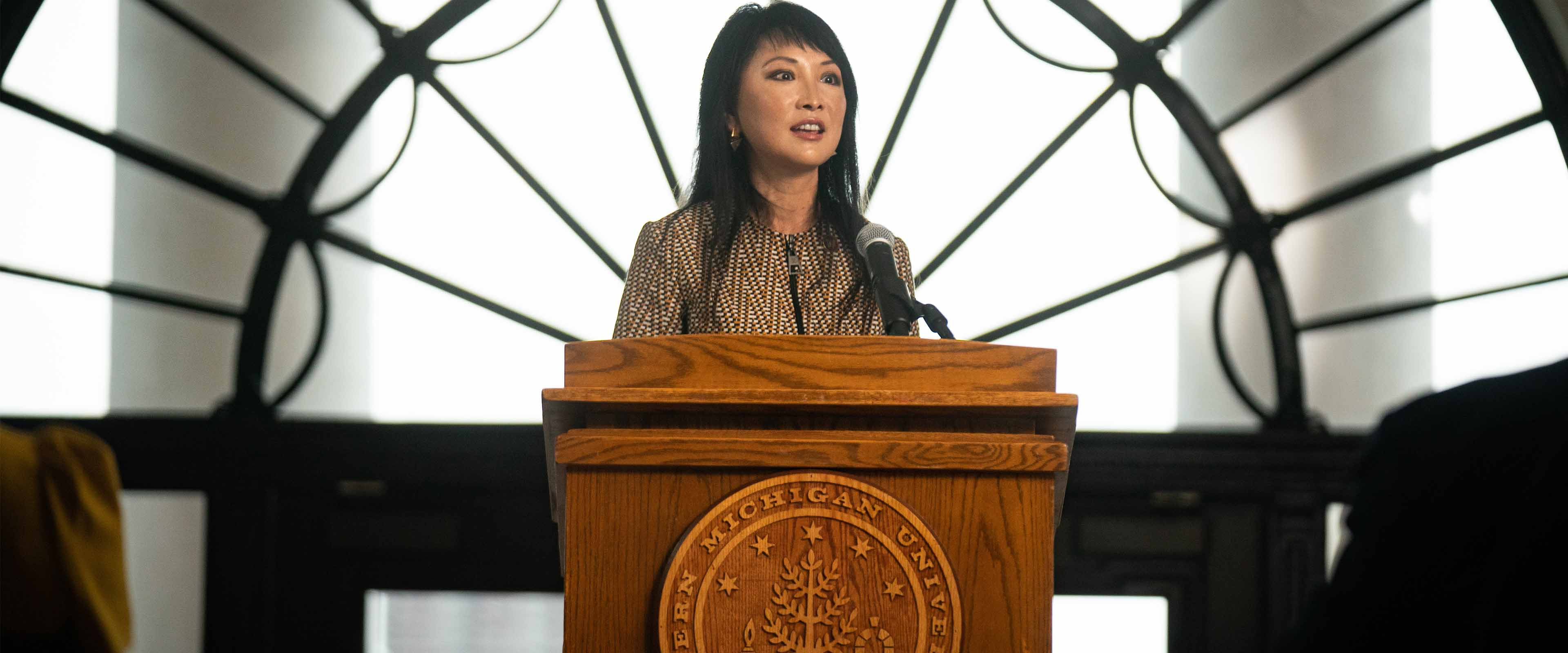 Lynn Chen-Zhang stands at the podium of Heritage Hall.