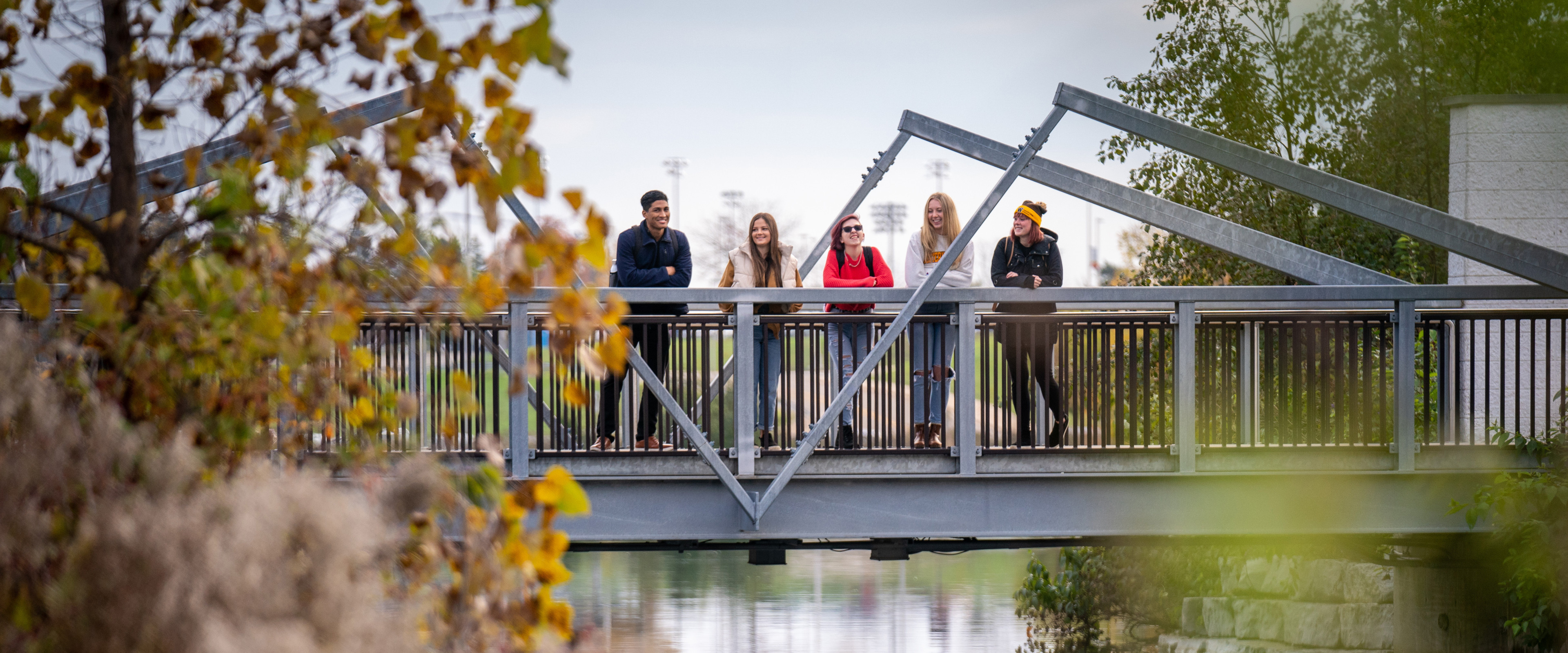 Students standing on the bridge at Goldworth Valley Pond.