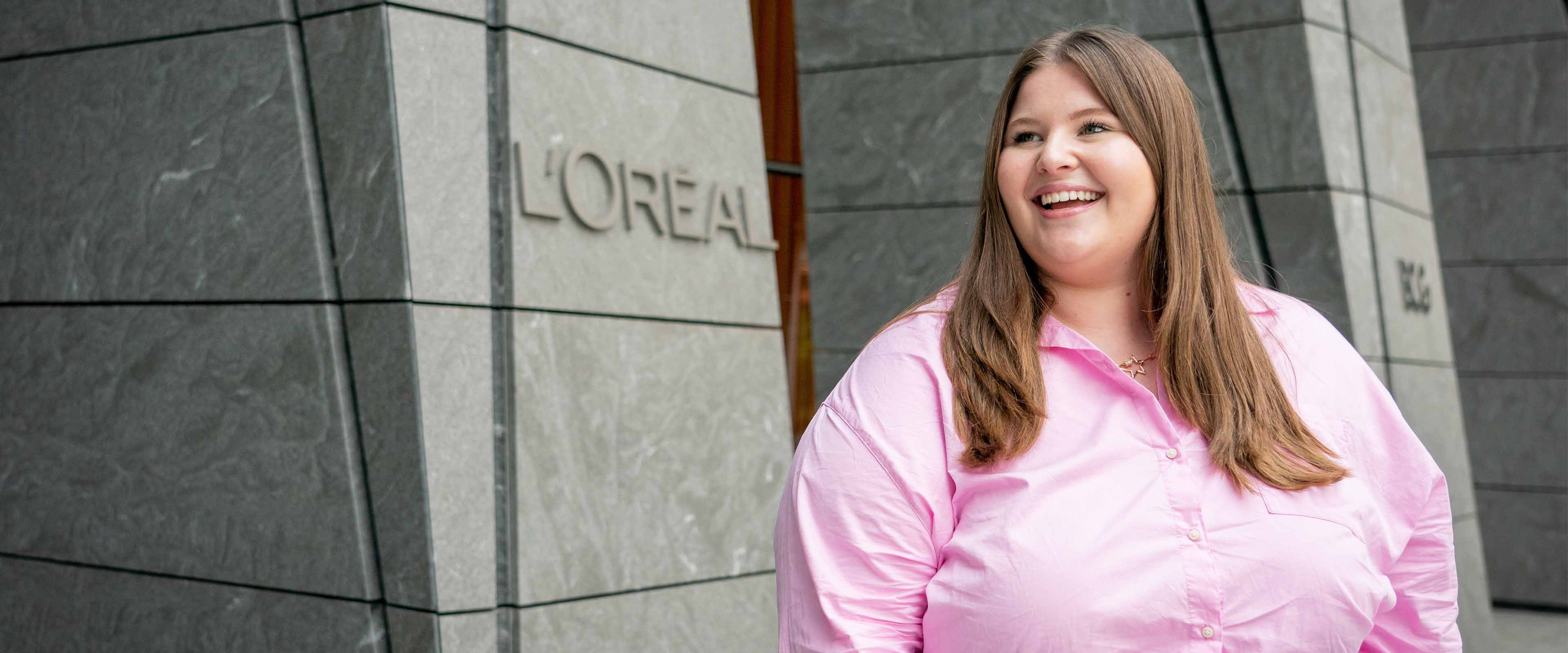 Samantha Morehead standing outside the L'Oreal building in New York City.