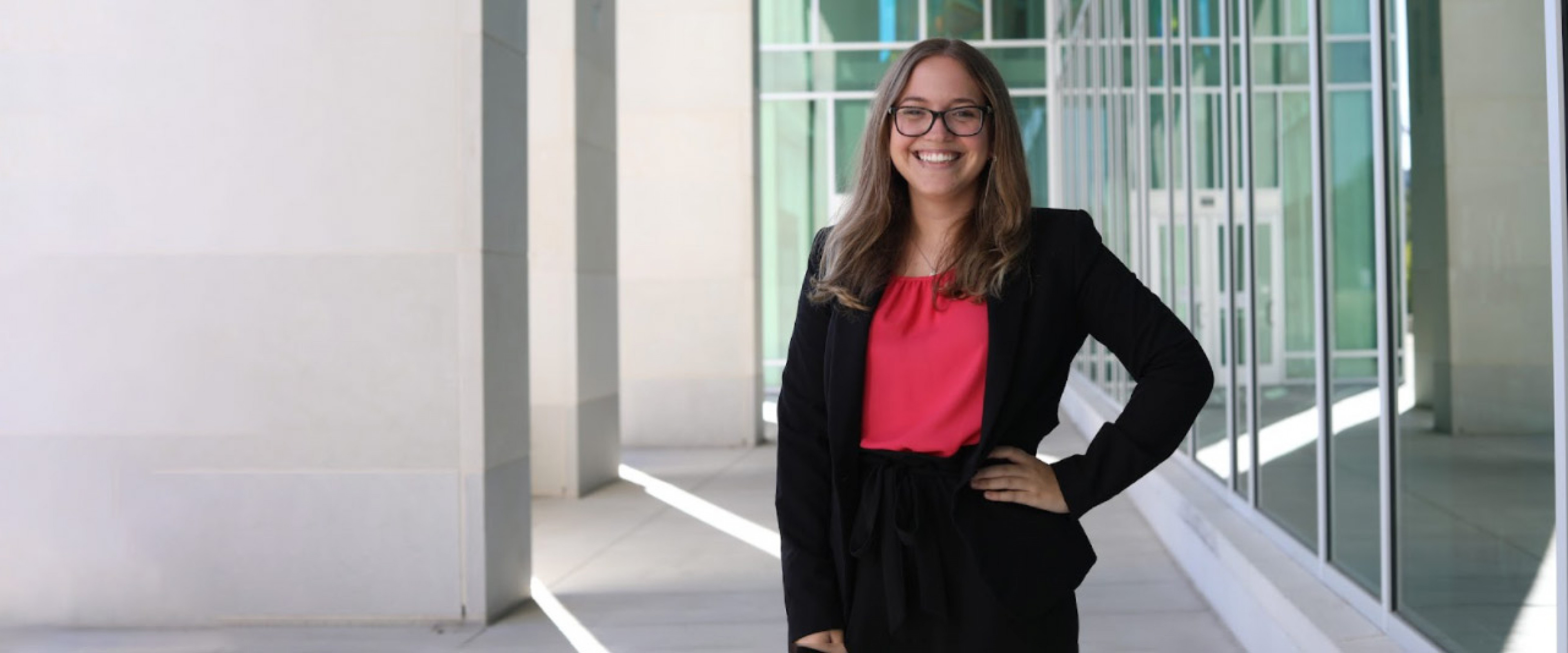 Allison Anker, Presidential Scholar in finance and commercial law, wearing a black jacket and magenta shirt.