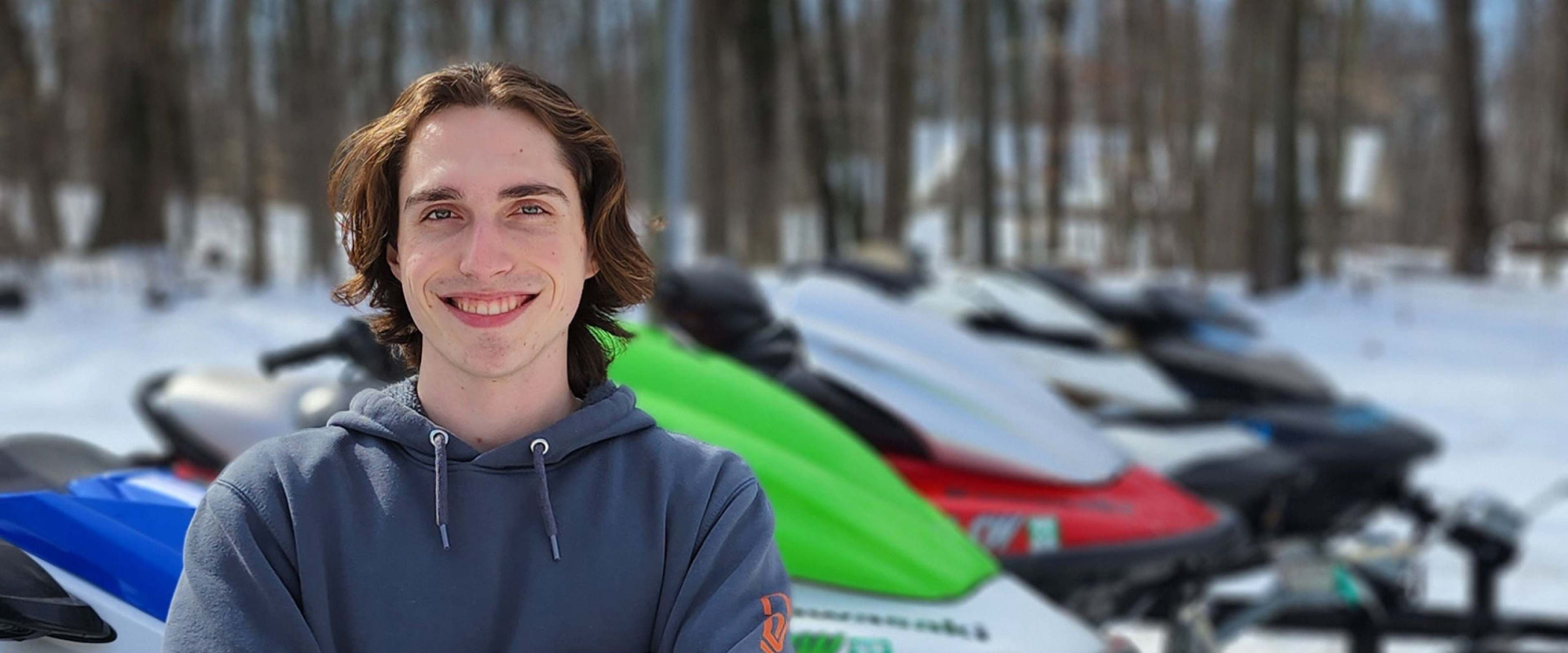 Smiling student with personal watercraft collection