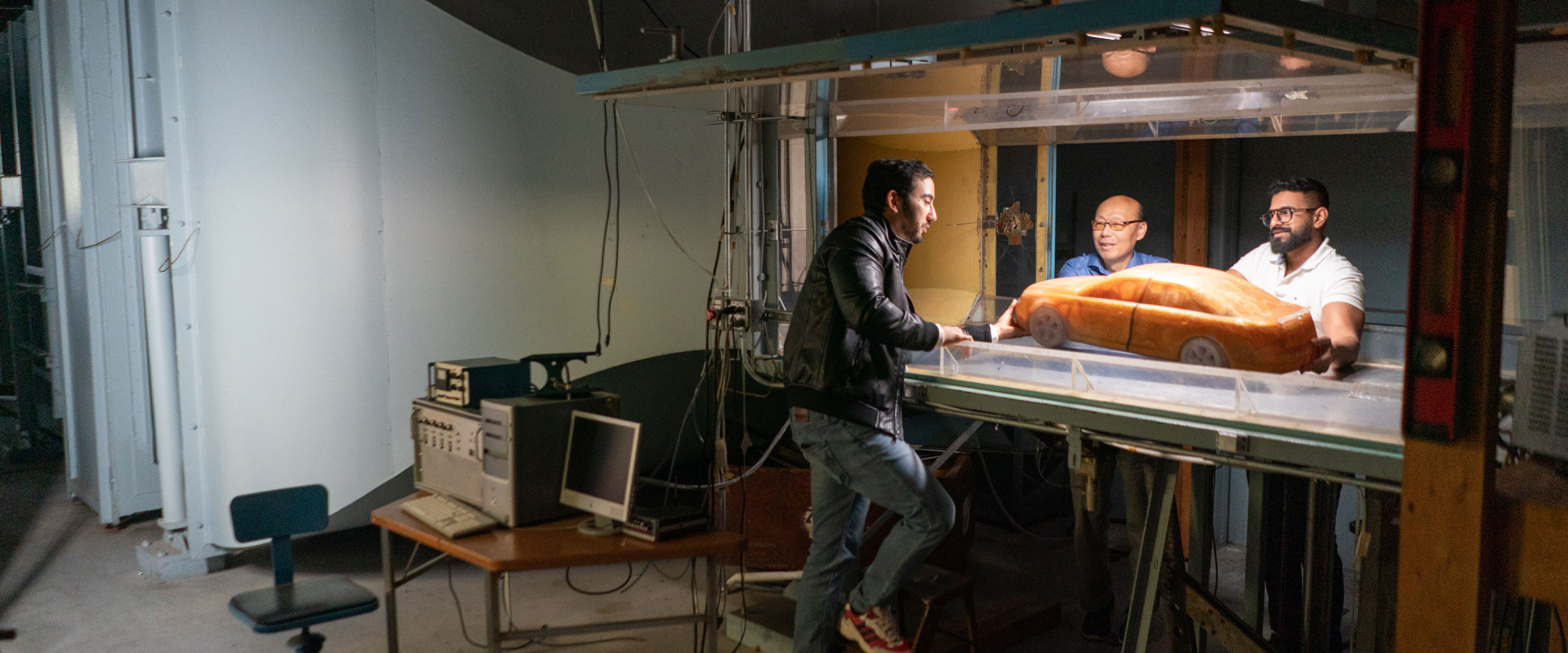 Liu in wind tunnel lab with two research students