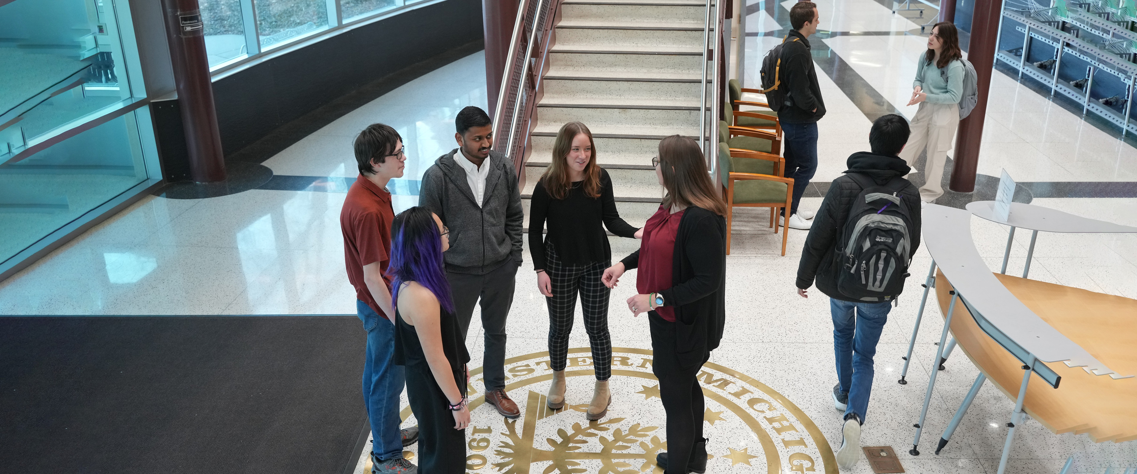 Group of students and faculty member in Floyd Hall lobby