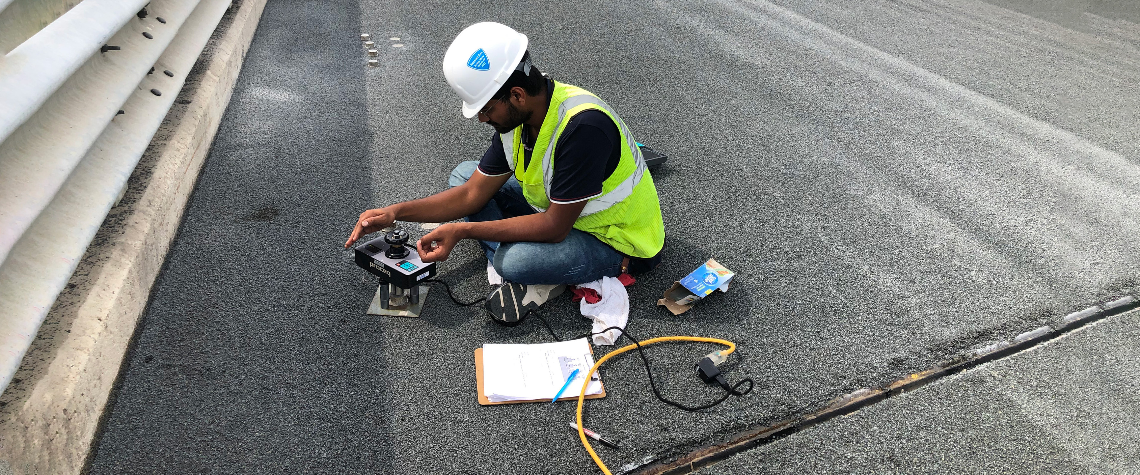 Worker on road installing sensors