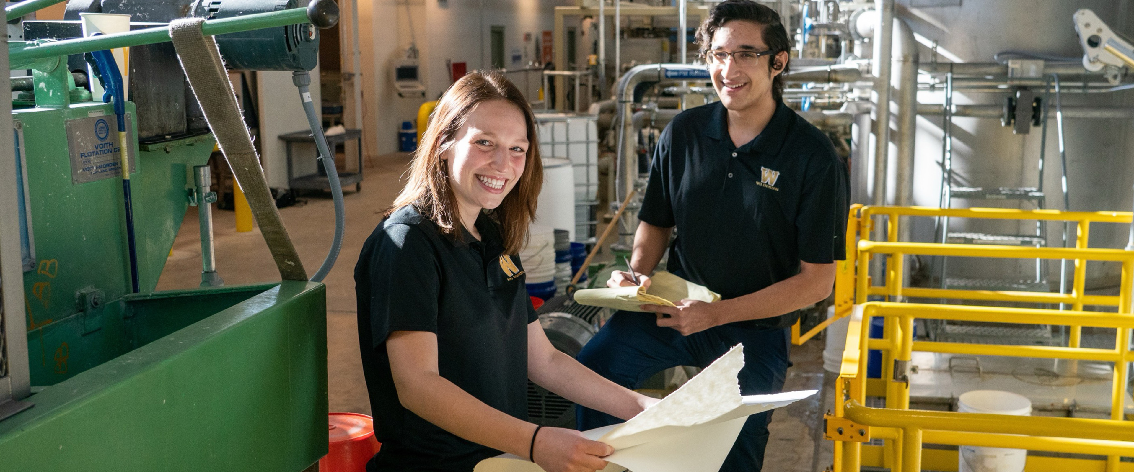 Two students working in the paper pilot plant.