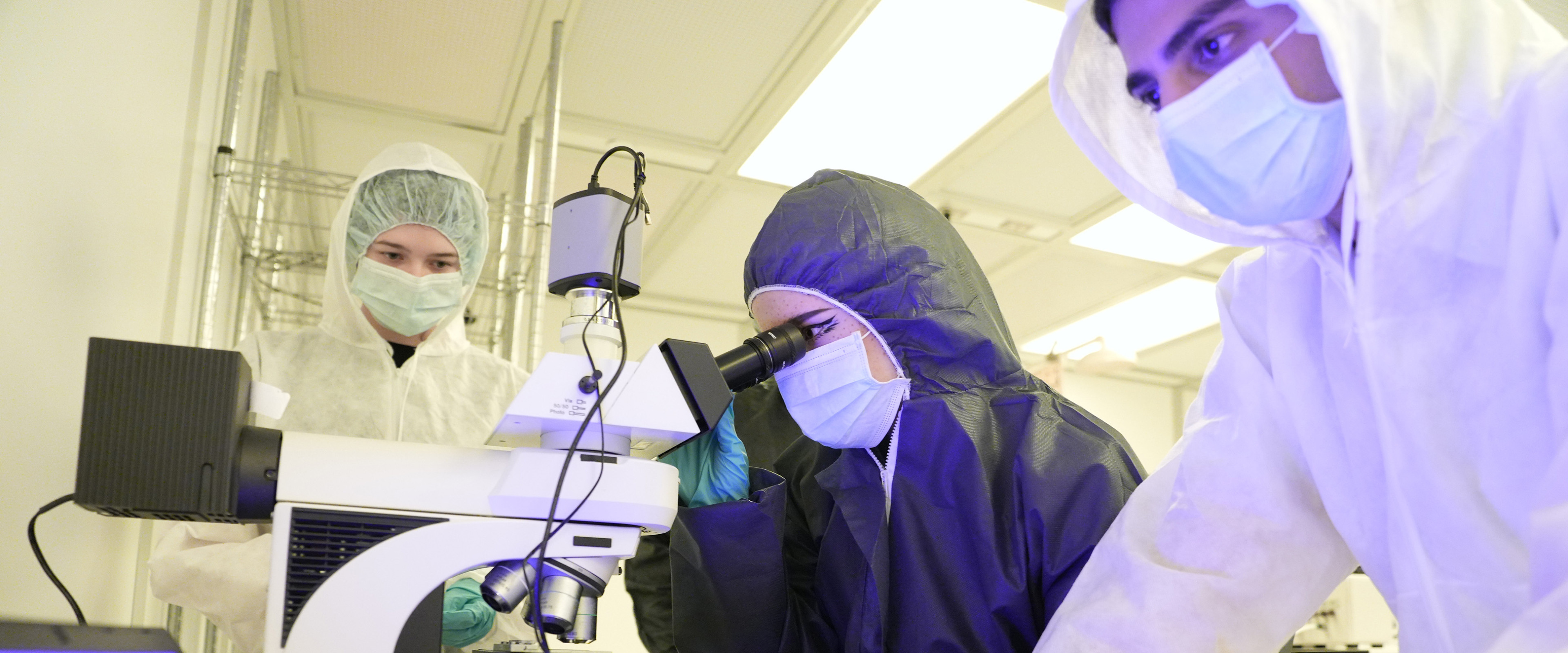 Three students working in clean lab