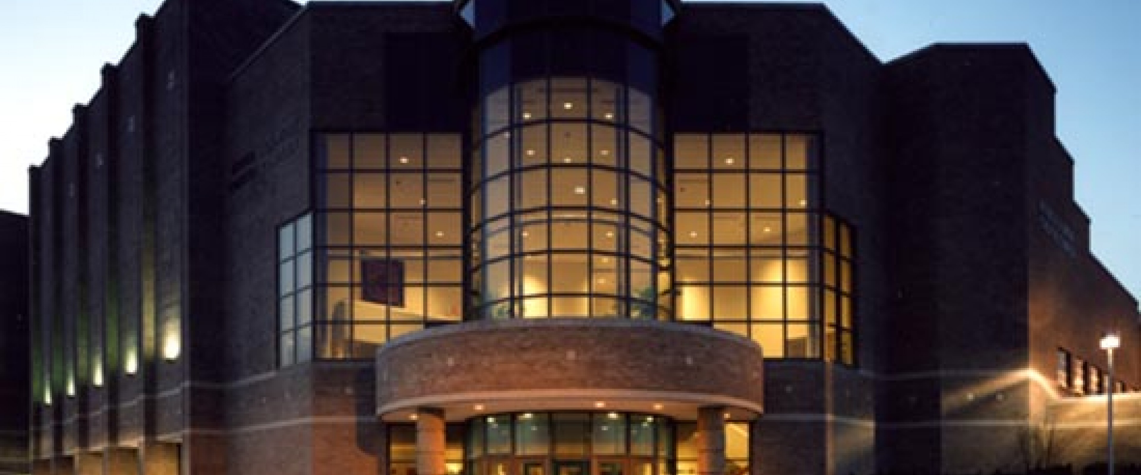 Front of the GIlmore Theatre Complex at night.