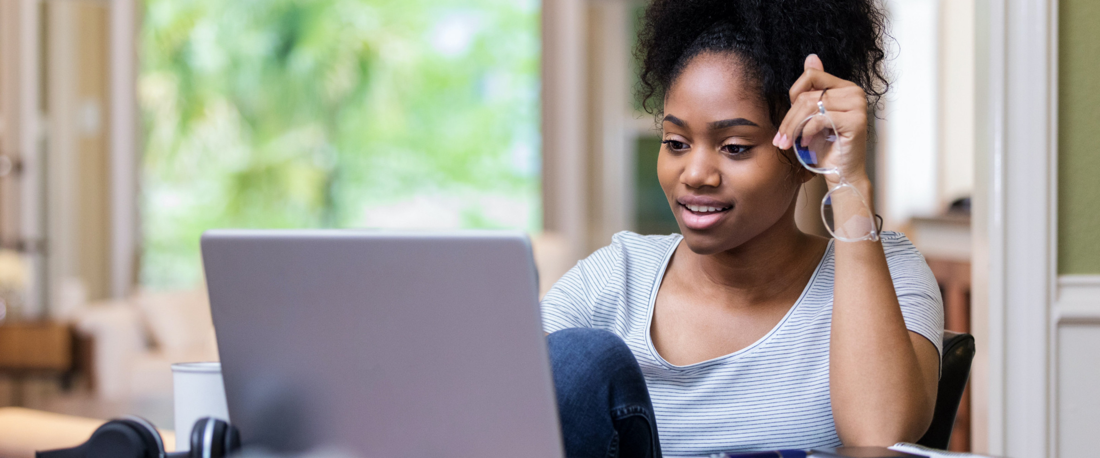 student sitting at desk with laptop.