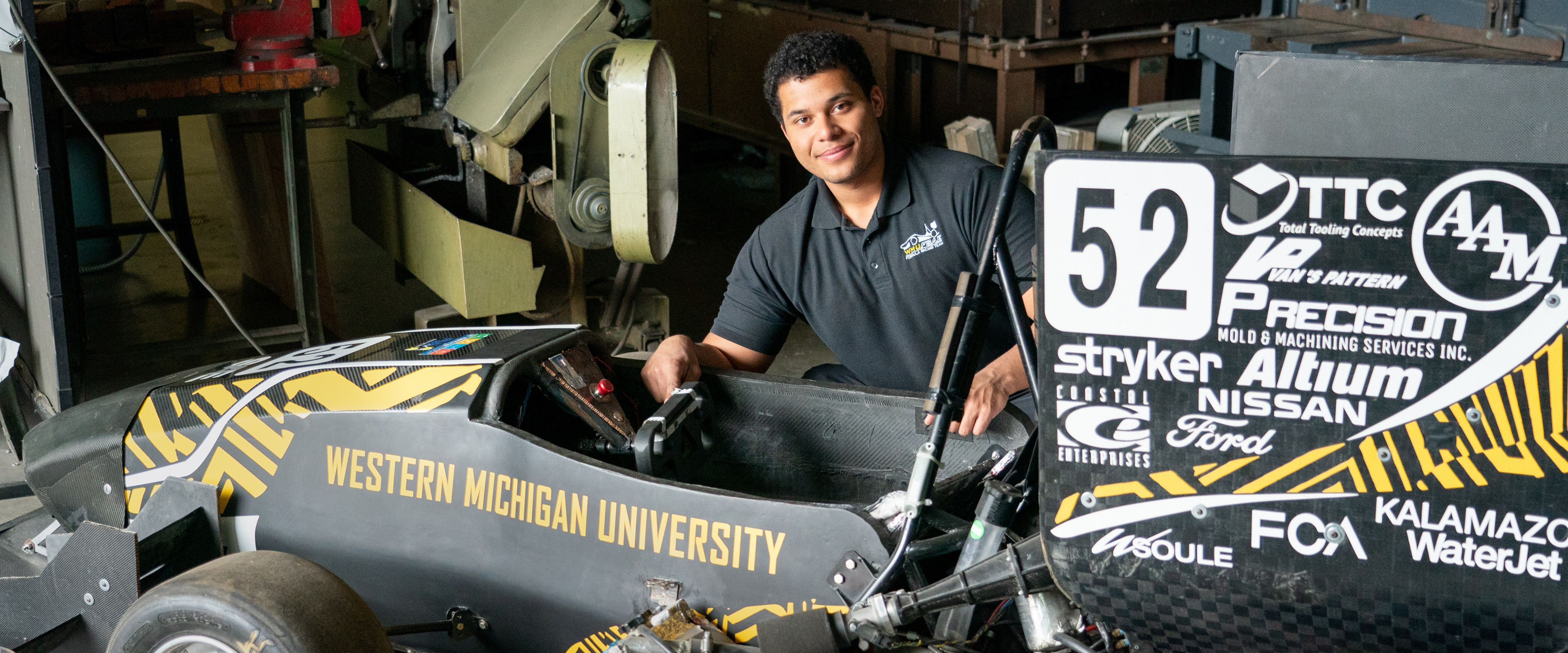 student with wmu car