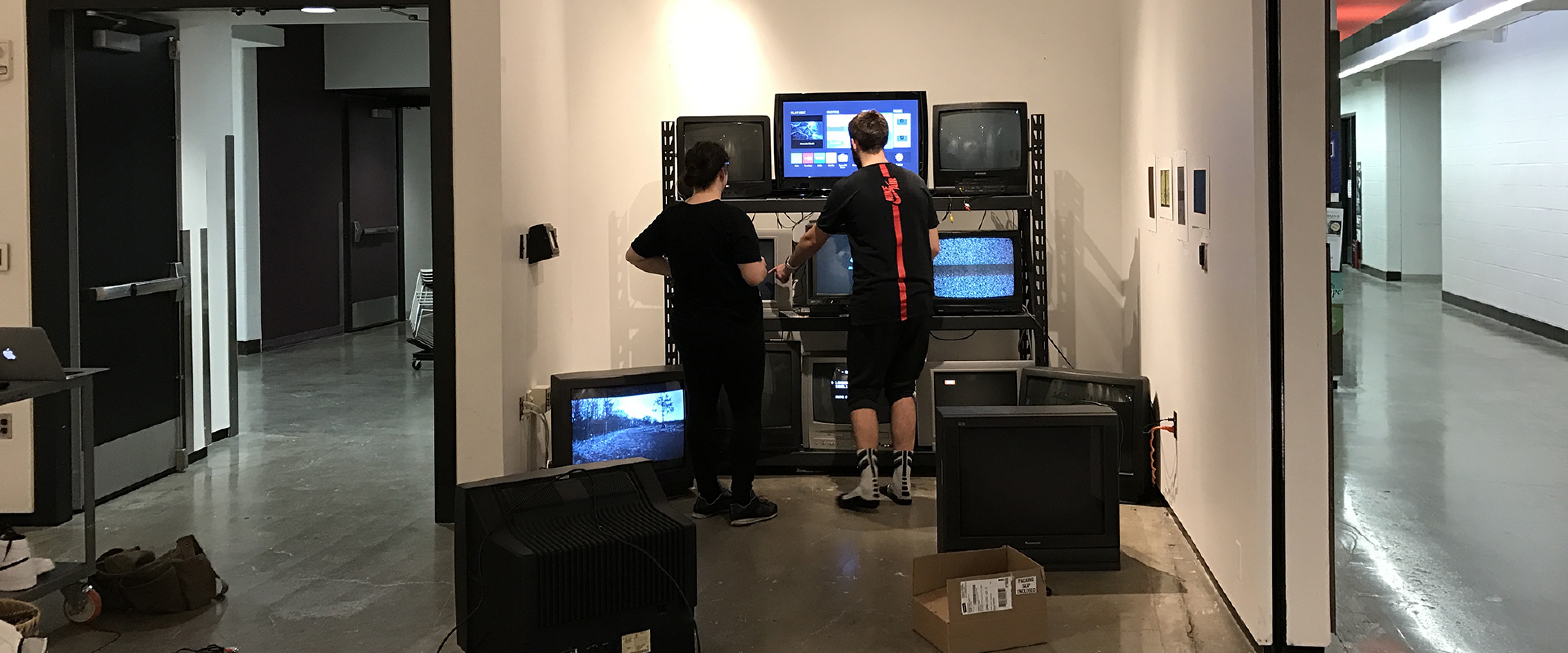 students setting up video installation