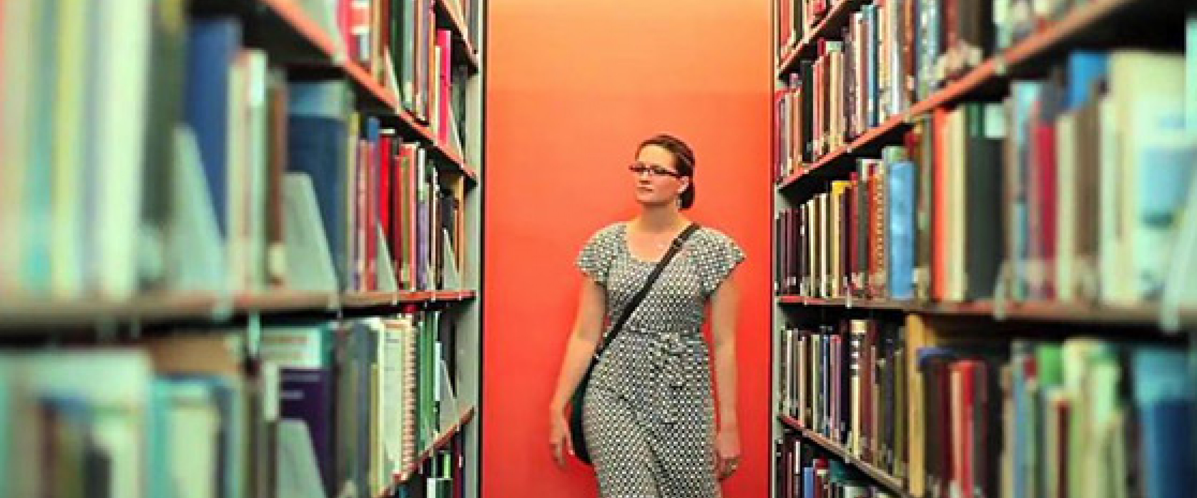 student walking through library
