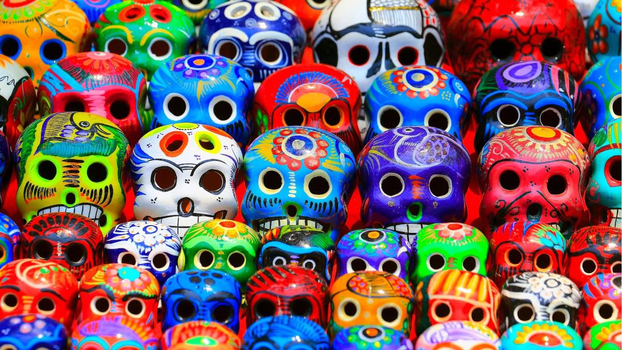 Ceramic skull heads painted in a wide variety of colors and designs.