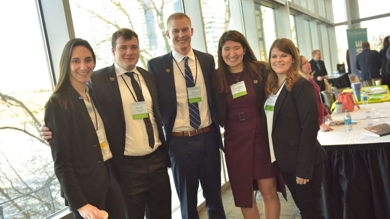 Five students in professional dress smiling during the 2018 conference.