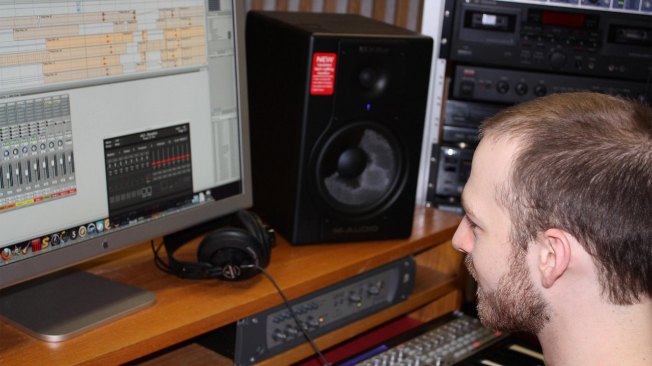 Photo of a student using music mixing software on a computer.
