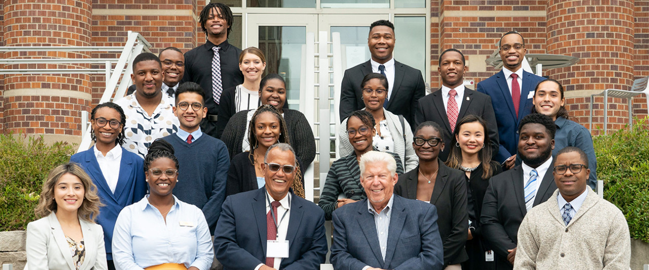Pictured are new and former Greenleaf Trust scholars with President Edward Montgomery, front row and third from left, and William D. Johnston, front row and second from right.