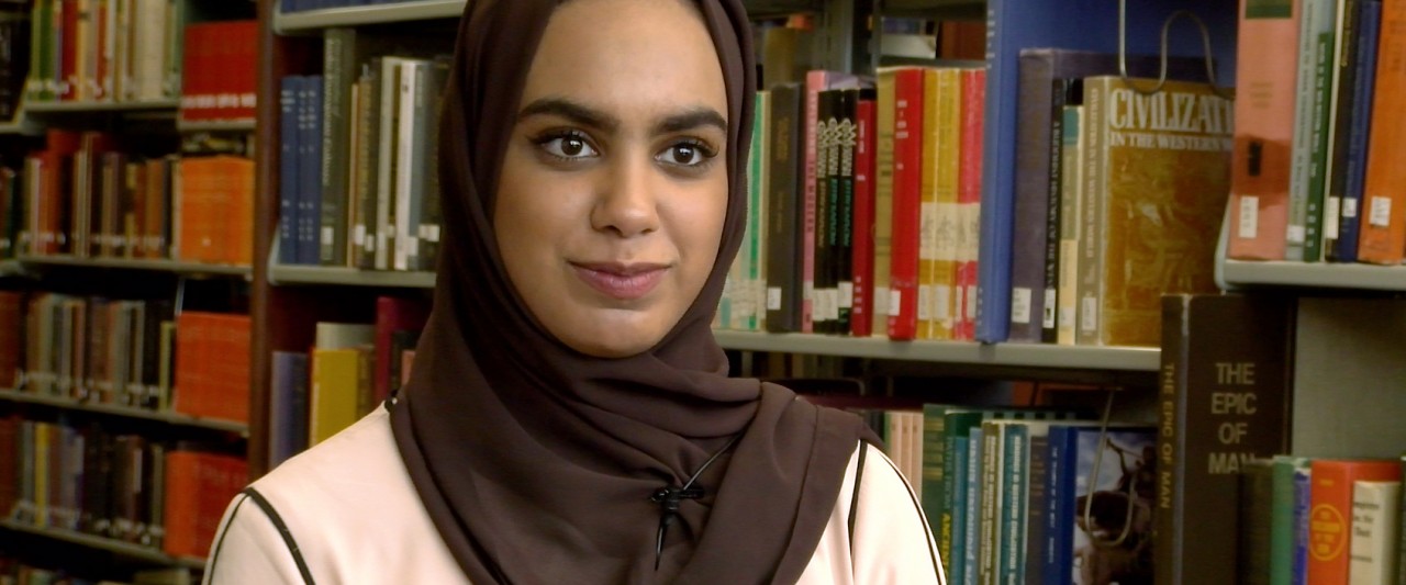 Shaikha Alarwahi sitting in the library