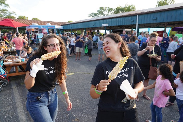 Western students, enjoying corn on the cob at the Farmers Market, downtown Kalamazoo