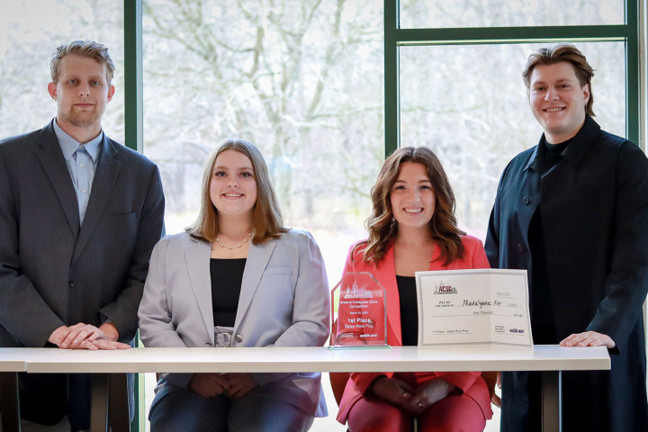 Four WMU sales program team members pose with an award.
