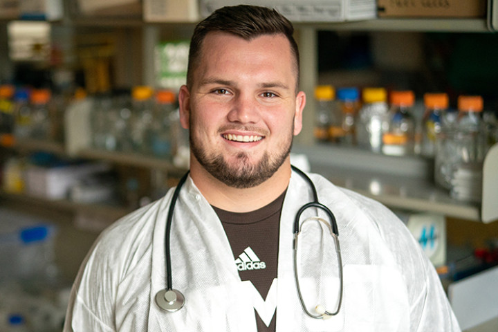 WMU student with stethoscope resting around his neck.