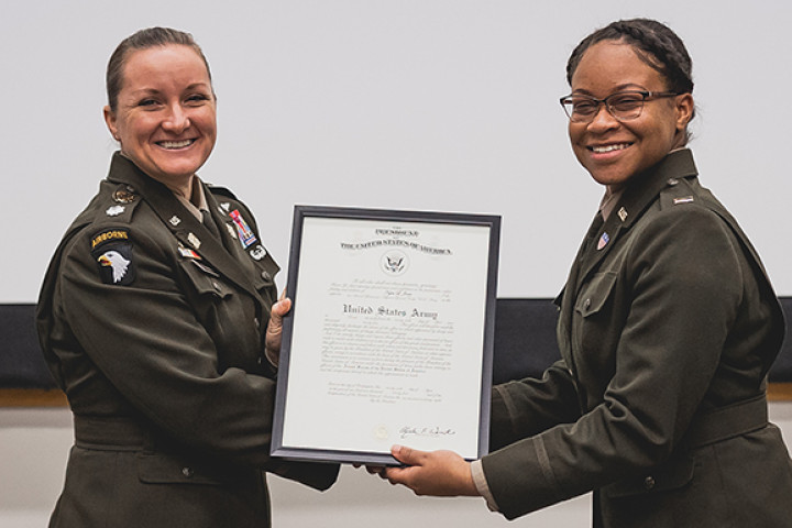 Lt. Col. Hinterman presenting an official document to a newly commissioned army officer.