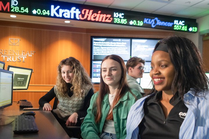 A group of students working together in the Greenleaf Trust Trading Room.
