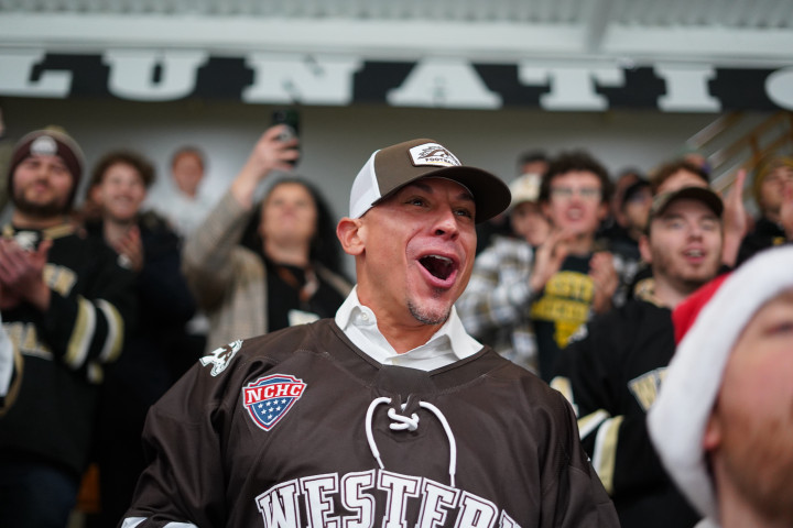 Lance Taylor wears a WMU baseball cap and hockey jersey and cheers in the Lawson Lunatics section of Lawson Arena.