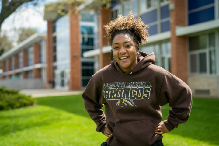 Image of a Merze Tate College student in Bronco sweatshirt smiling