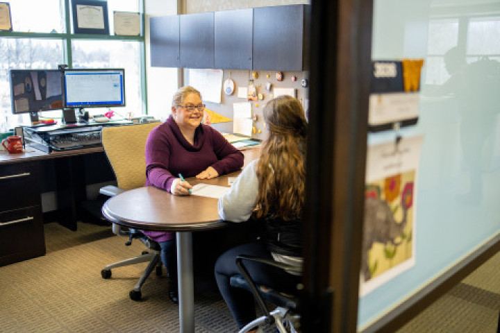 A student meeting with a WMU staff member.