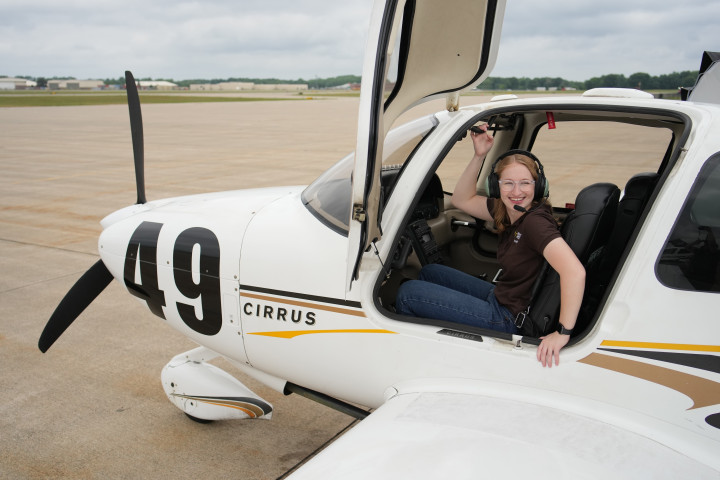 Laila Stein sitting in the cockpit of a Cirrus plane.