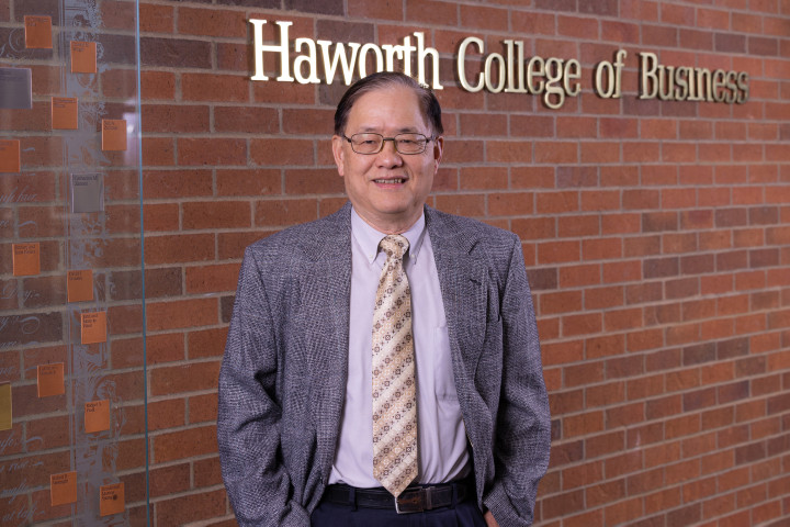 Dr. Bernard Han standing in front of a brick wall in the Haworth College of Business