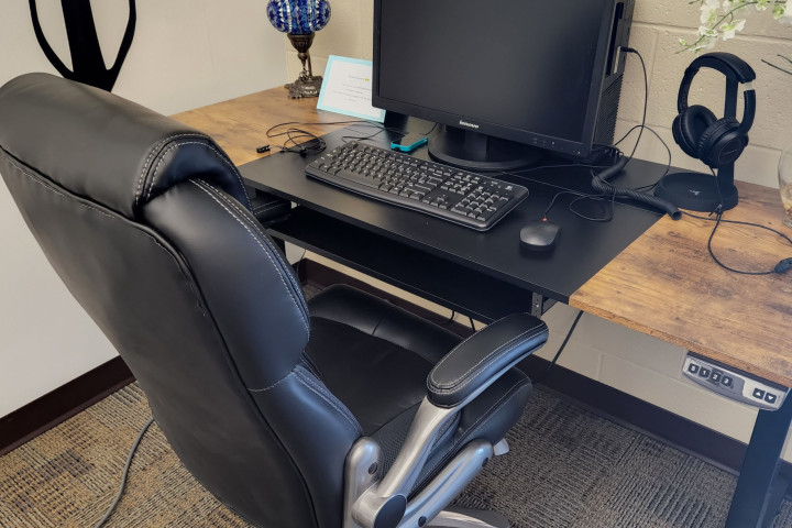 Computer and desk with chair and tools for biofeedback activity.