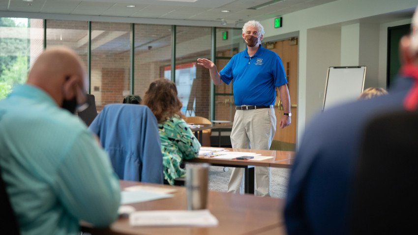 Tom Kelly instructs a classroom of socially distanced city employees