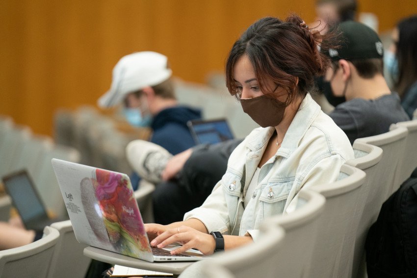 student on laptop wearing mask